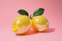 Two fresh lemons with green leaves on pink background, isolated for design use on packaging, labels, recipes, healthy food content, and culinary marketing materials.