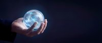 Businessman holding glowing crystal ball with swirling energy in cupped hands against dark background for fortune telling and future prediction concepts.