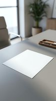 Blank white paper sheet on modern office desk with blurred workspace background for business documents and professional presentations.