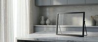 Modern minimalist kitchen interior with sleek marble countertop and contemporary black picture frame for home decor and design inspiration.
