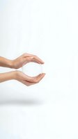 Female hands gently holding a clear crystal ball on white background, symbolizing future, clarity, and vision for business concepts.