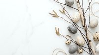 Easter composition with speckled eggs and pussy willow branches on white background. Spring holiday decoration with natural elements and copy space.