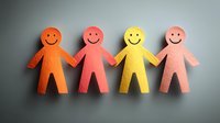 Colorful foam cutout figures holding hands symbolizing unity, teamwork, and friendship in warm orange, red, yellow, and pink tones against neutral gray background.