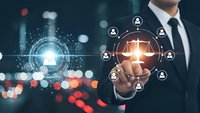 Professional businessman touching glowing digital network interface with user icons and connections representing modern business technology and communication.