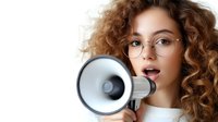 Young woman with curly auburn hair and glasses holding megaphone against white background, expressing announcement, promotion, or communication concept for marketing and advertising campaigns.