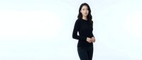 Young Asian businesswoman in black dress standing confidently on white background, isolated for professional corporate design projects.