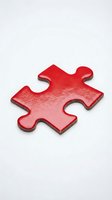 Single red puzzle piece with metallic finish on white background, representing problem solving and business strategy concepts.