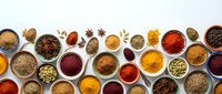 Colorful spices and herbs collection in bowls and spoons arranged on white background. Cooking ingredients for culinary recipes and seasoning food preparation.