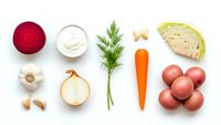 Fresh vegetables arranged on white background including red beet, cabbage, carrot, onion, potatoes, garlic and dill for healthy cooking and meal preparation.