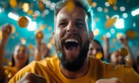 Excited bearded man in yellow t-shirt celebrating sports victory with crowd of fans, emotional reaction with bokeh lights and falling coins in background.