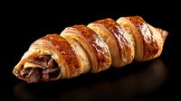 Fresh baked chocolate croissant with flaky golden brown layers and dark chocolate filling on black background, dramatic lighting creates appetizing mood.