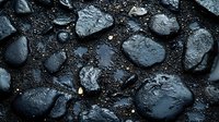 Wet black stones with water drops on dark background create dramatic texture and pattern for spa, wellness, and meditation designs and backgrounds.