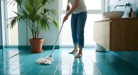Woman mopping turquoise tile floor in modern kitchen with palm plant. Household cleaning and maintenance concept for domestic hygiene advertisements.