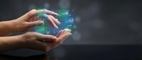 Hands holding glowing digital hologram with financial charts and data analytics interface for business technology and innovation concepts.