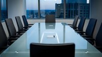 Modern corporate boardroom with glass conference table and executive chairs overlooking city skyline at dusk for business meetings and presentations.