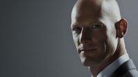 Professional bald businessman in suit with confident expression against gray background for corporate marketing and business presentations.