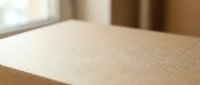 Close-up of natural cork board texture with fine grain detail, soft lighting creates warm atmosphere for office and home organization projects.