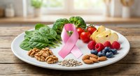 Healthy nutrition plate with pink ribbon, fresh vegetables, fruits, nuts and seeds for cancer awareness and prevention diet on wooden kitchen table.