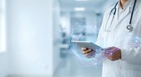 Doctor using digital tablet with futuristic holographic interface in modern hospital setting for telemedicine and healthcare technology applications.