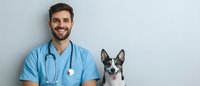 Smiling veterinarian in blue scrubs with stethoscope next to happy black and white husky mix dog against light background, healthcare concept.