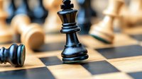 Black queen chess piece standing on wooden chessboard with blurred white pieces in background, macro shot showing strategy and leadership concept in gaming.