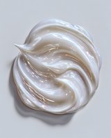 Creamy white cosmetic texture with swirling pattern on light background, showcasing luxury skincare product consistency.