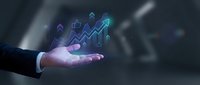 Businessman hand holding glowing digital growth chart with upward arrow and financial icons for business analytics and investment strategy.