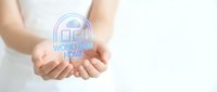 Hands holding glowing holographic house icon with working from home text, remote work concept for business and technology applications.