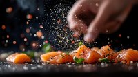 Fresh salmon sashimi pieces with falling sea salt and spices on dark background, dramatic food photography with bokeh light effects and garnish.