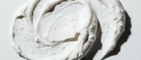 Creamy white cosmetic product with swirled texture on isolated background, suitable for skincare, beauty packaging, and design mockups.
