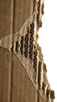 Torn cardboard with wavy stitching detail and layered edges, showing natural kraft paper texture and craftsmanship for packaging, design, and creative projects.