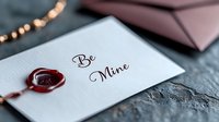 Romantic love letter with red wax seal and calligraphy text Be Mine on white paper for Valentine's Day greeting card design and wedding invitation.
