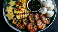 Grilled pineapple and peach slices with sticky rice and soy dipping sauce on banana leaf, garnished with fresh herbs and starfruit for tropical presentation.