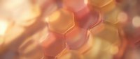 Hexagonal honeycomb structure with warm golden and amber tones, soft bokeh background, abstract molecular or cellular pattern for science, technology, and design projects.