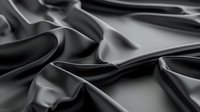 Elegant black silk fabric with soft waves and folds creating luxurious texture and dramatic shadows on dark background, suitable for fashion and luxury design projects.