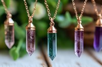 Rose gold crystal pendant necklaces with amethyst and green gemstone points hanging on chains for jewelry making and spiritual accessories.