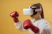 Young woman in white sweatshirt wearing VR headset and red boxing gloves in fighting stance against yellow background, exploring virtual fitness training.