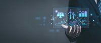 Businessman holding virtual screen with renewable energy icons including solar panels, wind turbines, and battery storage, showcasing green technology innovation.