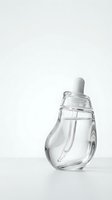Clear glass dropper bottle with white rubber bulb on clean white background for skincare and cosmetic product packaging design.