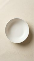 Empty white ceramic bowl on neutral beige textured background, overhead view. Minimalist tableware for food styling, restaurant menus, culinary content, and dining design projects.