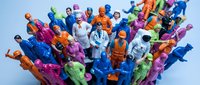 Colorful plastic toy figures collection featuring diverse characters in bright costumes and uniforms arranged together for play and entertainment.