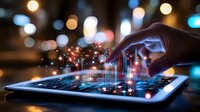 Hand touching digital tablet with glowing data visualization and sparkles against blurred city lights background at night.