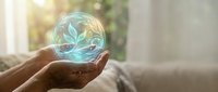 Hand holding glowing sphere with leaf pattern, symbolizing environmental sustainability, green energy, and eco-friendly innovation for business and nature concepts.