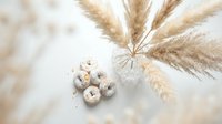 Dried pampas grass stems in glass vase with speckled quail eggs on neutral background for natural home decor and Easter spring styling.