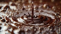 Liquid chocolate drop splash creating ripple effect with droplets against dark brown background with bokeh lights, captured in macro photography.