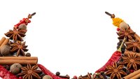 Aromatic spices frame with cinnamon sticks, star anise, cardamom and peppercorns on white background for culinary design and cooking projects.