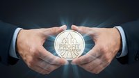 Businessman hands protecting glowing coin with SEO optimization symbol, representing digital marketing strategy and business growth investment.