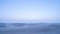 Serene winter landscape with snow-covered mountains and frozen lakes under soft blue twilight sky, suitable for nature backgrounds and seasonal designs.