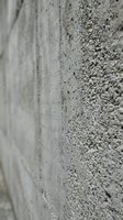 Raw concrete wall surface with rough textured finish showing industrial construction material and architectural detail for modern design projects.