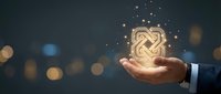 Businessman hand holding glowing infinite knot symbol with sparkling light particles against blurred cityscape background for business growth and success concepts.